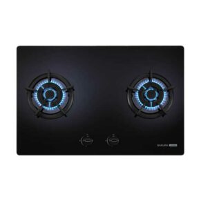 Black glass gas cooktop with two lit burners and blue flames; front-center knobs and Sakura brand in the corner.