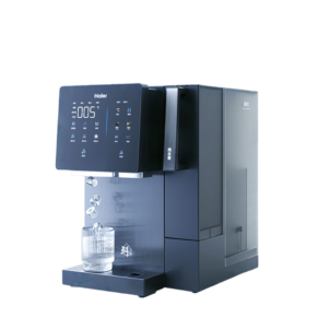Haier coffee machine with a digital touch panel on the left and a water reservoir on the right, dispensing into a glass on the drip tray.